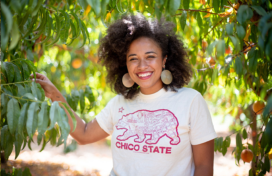 Chico State student at the peach orchard